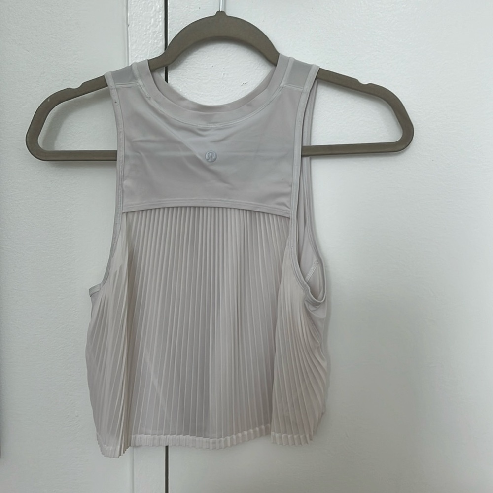White lululemon athletic top with ruffled back. Size 4